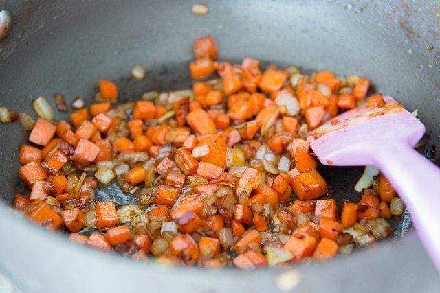Sauteing chopped carrots and onion in nonstick pan for Cauliflower Fried Rice with Chicken